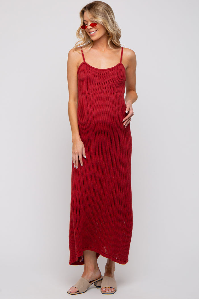 woman wearing a red ribbed maternity maxi dress with adjustable straps and a visible baby bump