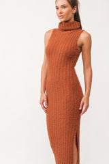 woman wearing a ribbed rust-colored sleeveless knit turtleneck dress with side slits