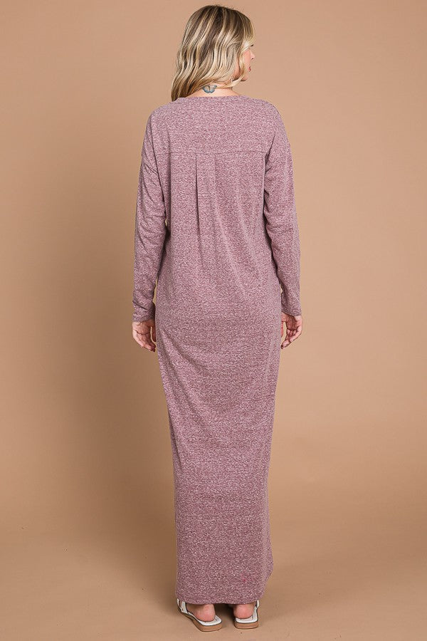 woman wearing a long sleeve mauve maxi dress with a relaxed fit, view of the back