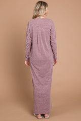 woman wearing a long sleeve mauve maxi dress with a relaxed fit, view of the back