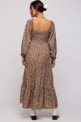 woman wearing a brown floral maternity maxi dress with smocked bodice and long sleeves
