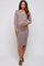 woman wearing a light purple long sleeve maternity dress and holding her baby bump