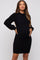 woman wearing a black ribbed long sleeve maternity dress and holding her baby bump