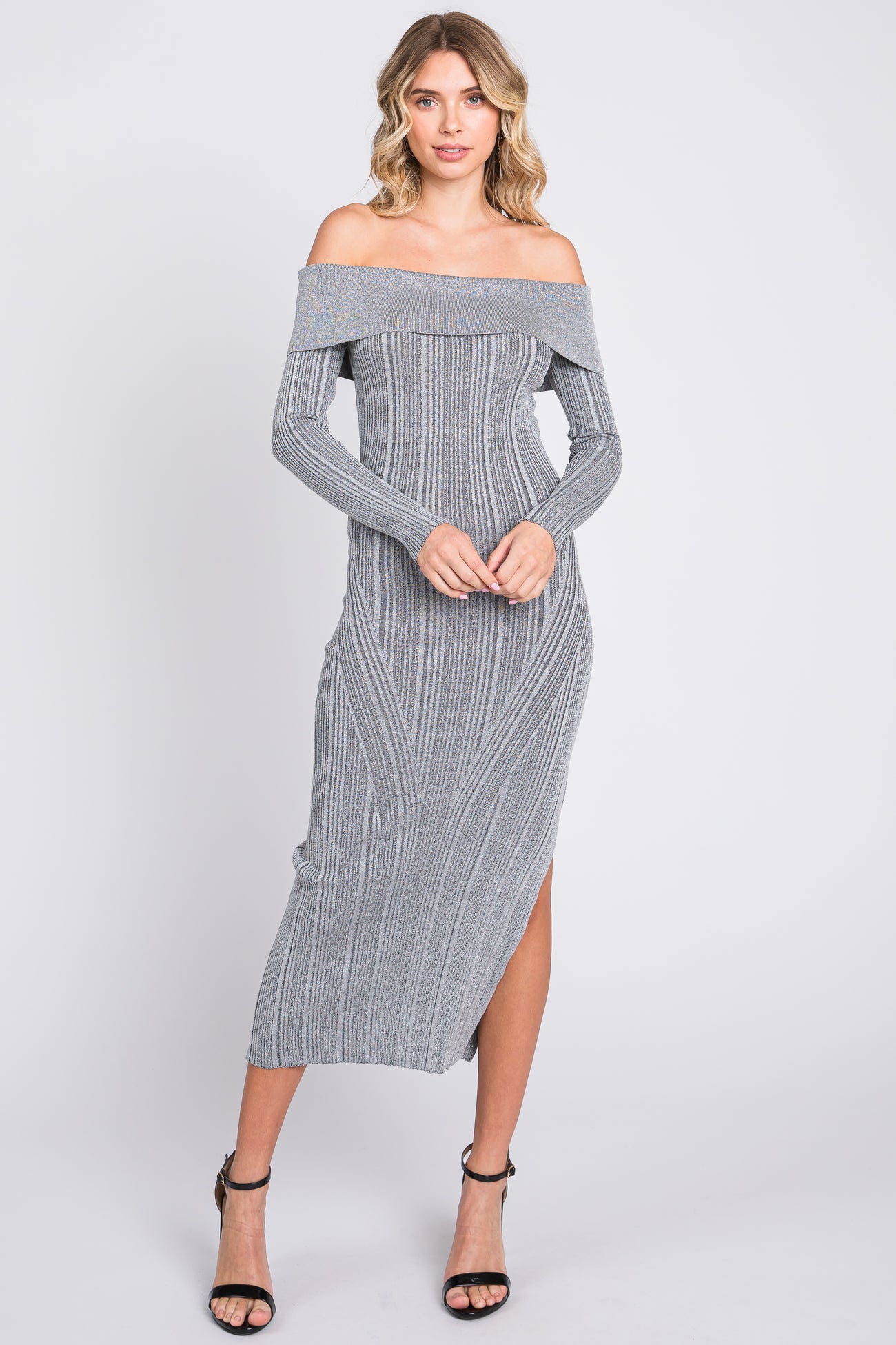 woman wearing a gray off-the-shoulder ribbed knit maxi dress with a thigh-high slit and long sleeves