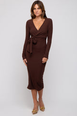 woman wearing a chocolate brown long sleeve wrap dress with a tie waist and a midi length