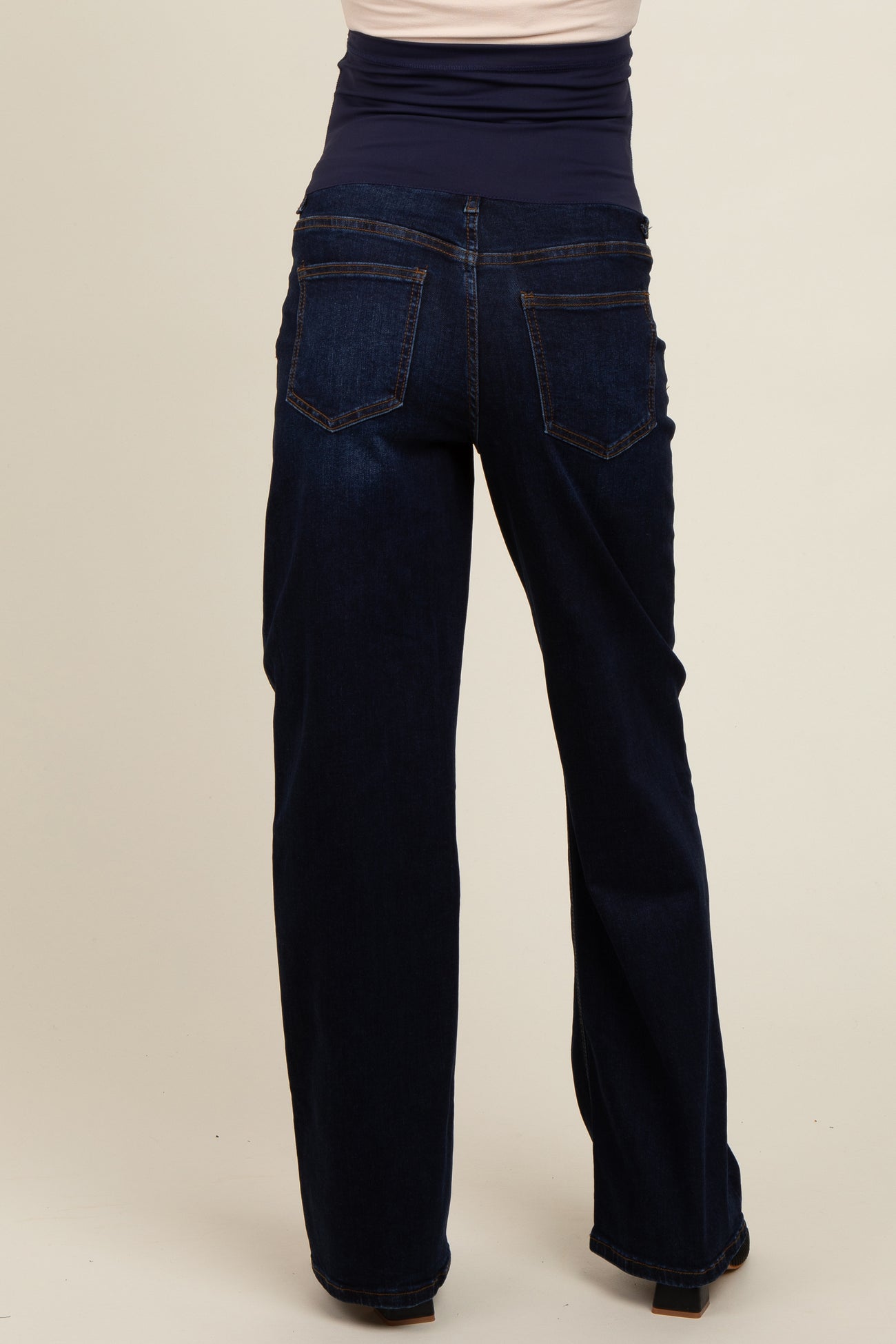 maternity wear dark blue bootcut jeans viewed from the back, featuring a stretchy waistband