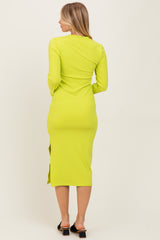 woman wearing a neon green long sleeve midi dress with a side split, viewed from the back