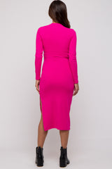 woman wearing a bright pink long sleeve maternity dress with side slits and a fitted silhouette, showing her back