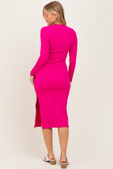 woman wearing a hot pink long sleeve midi dress with a side slit and form-fitting style