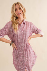 woman wearing a pink sequin button-up shirt dress with long sleeves and two side pockets