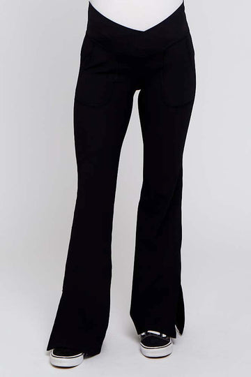black maternity yoga pants with flared legs and front pockets, worn by a model with a visible baby bump