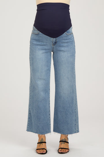maternity wear high-waisted wide-leg jeans in light blue with a navy belly band, model wearing them with open-toed sandals