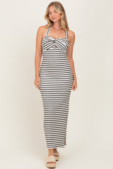 woman wearing a black and white striped maxi dress with a halter neckline and twist front detail