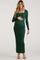 woman wearing a dark green long sleeve maternity dress and holding her baby bump