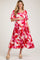 woman wearing a red floral print maternity dress with short puff sleeves and a baby bump visible
