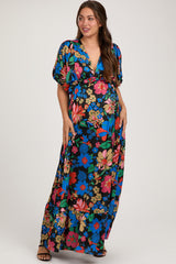 woman wearing a floral print maternity maxi dress with short sleeves and a v-neckline, showcasing her baby bump