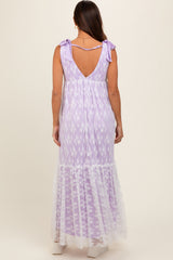 woman wearing a lavender maternity maxi dress with a lace hem and bow straps, showing her back