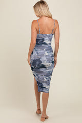 woman wearing a fitted midi dress in blue and gray abstract print with spaghetti straps and ruching details