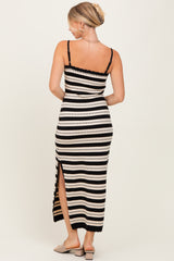 woman wearing a black and white striped maxi dress with a slit, showing the back and straps of the dress