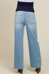 woman wearing light blue wide leg maternity jeans with a stretchy navy waistband