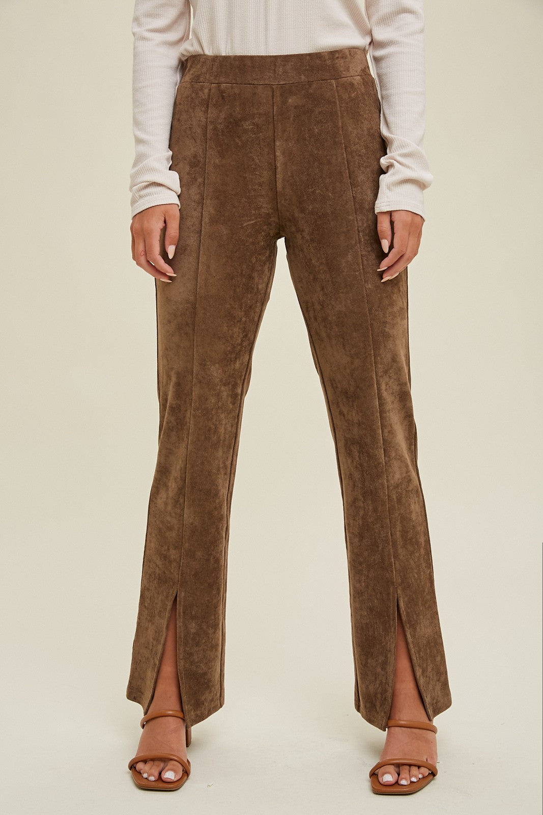 woman wearing brown split hem wide legged pants with a soft texture and a high waist