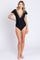 woman wearing a black one-piece swimsuit with colorful embroidery and flutter sleeves