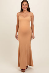 woman wearing a light brown ribbed maternity maxi dress with thin straps and showing her baby bump