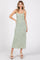 woman wearing a long green floral print maxi dress with thin straps and a fitted silhouette