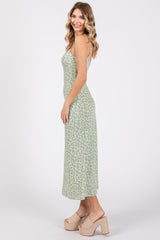 woman wearing a green floral print maxi dress with spaghetti straps and cork wedge sandals