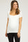 woman wearing a white short sleeve maternity top and showing her baby bump