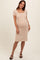 woman wearing a beige crochet maternity dress with short puff sleeves and a fitted silhouette, showcasing her baby bump