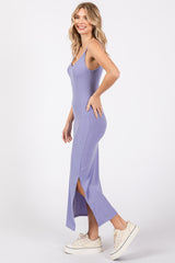 woman wearing a lavender ribbed maxi dress with side slits and paired with white sneakers