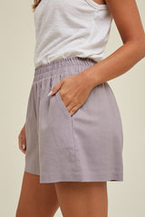 woman wearing light purple casual shorts with an elastic waistband and side pockets