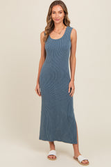 woman wearing a blue ribbed maxi dress with a scoop neckline and side slit