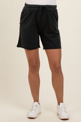 woman wearing black maternity shorts with a drawstring waist and relaxed fit