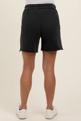woman wearing black maternity shorts, view of the back, with elastic waistband and casual style