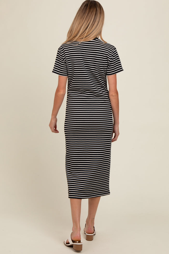 woman wearing a black and white striped maternity dress with short sleeves, shown from the back
