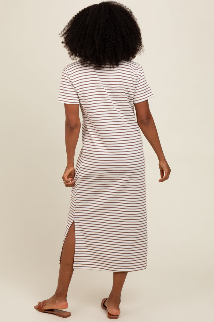 woman wearing a brown and white striped short sleeve maxi dress with side slits, seen from the back