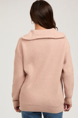 woman wearing a soft pink maternity sweater with a relaxed fit and ribbed texture, viewed from the back