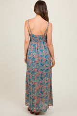 woman wearing a floral patterned maternity maxi dress with adjustable straps and a smocked back detail