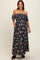 woman wearing a navy floral off-shoulder maternity maxi dress with pockets and a fitted bodice, displaying a baby bump