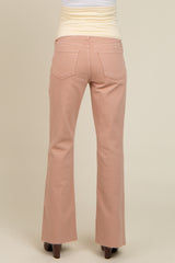 woman wearing light pink maternity flared jeans, viewed from the back, showing the waistband and pockets