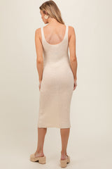 woman wearing a beige ribbed maternity dress with a fitted silhouette and scoop back, shown from the back