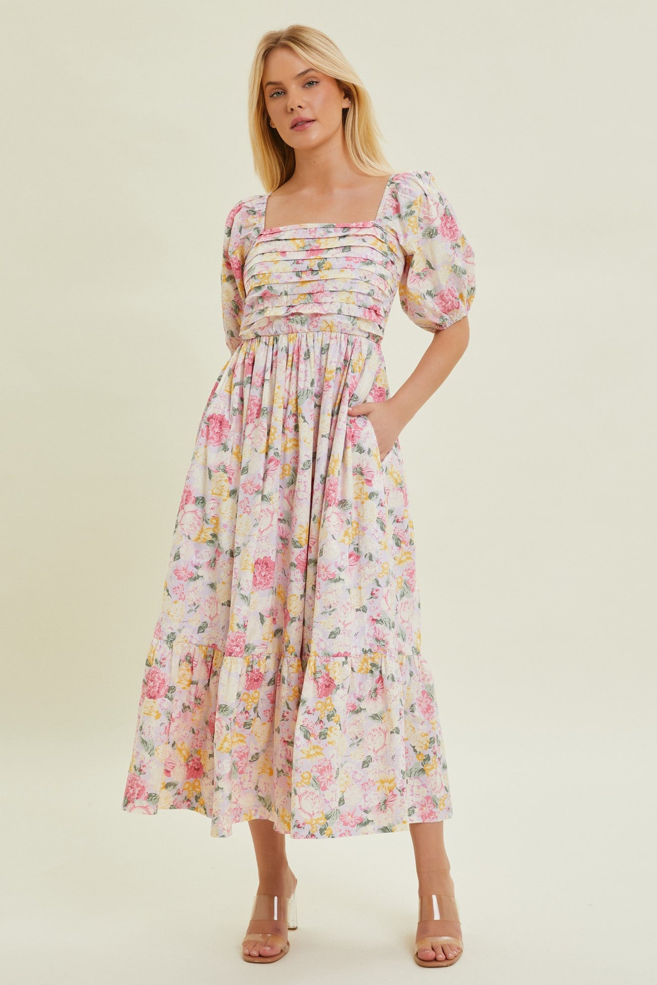 woman wearing a floral print maxi dress with puff sleeves and a ruched bodice