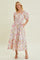 woman wearing a floral print maxi dress with puff sleeves and a ruched bodice