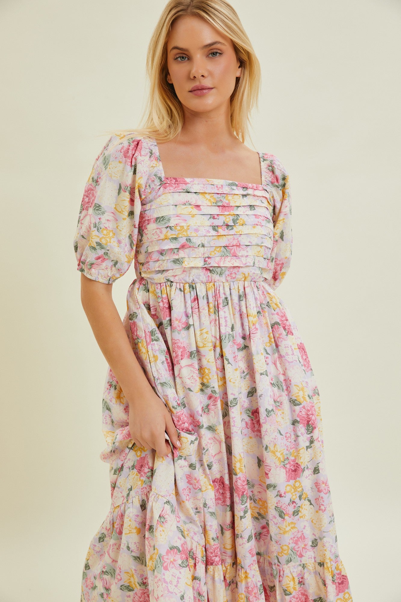 woman wearing a floral square neck maxi dress with puff sleeves and gathered bodice