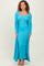 woman wearing a turquoise ribbed maxi dress with a long cardigan and strappy heels