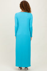 woman wearing a long sleeve ribbed maxi dress in bright turquoise from the back