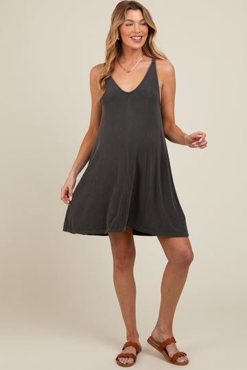 woman wearing a dark gray maternity swing dress with a v-neckline and relaxed fit, showcasing her baby bump