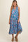 woman wearing a colorful floral sleeveless maternity dress with a tiered hem and a relaxed fit
